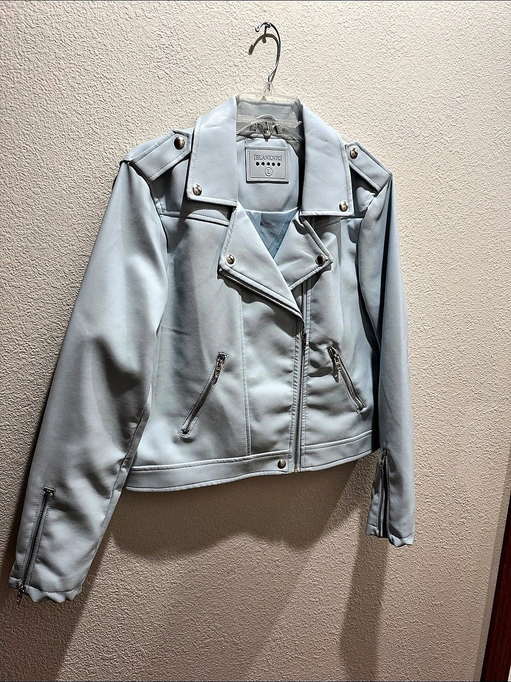 BLANKNYC Faux Leather Moto Jacket, light blue with silver zippers and snaps.